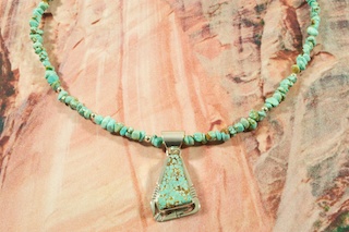 Genuine Number 8 Mine Turquoise set in Sterling Silver Pendant on a Number 8 Mine Turquoise Necklace.  Sterling Silver Beads, Cones and Clasp. Created by Navajo Artist Phillip Sanchez. Signed. The Number 8 mine is located in Eureka County Nevada. Since 1976 there has been no Number 8 Turquoise mined. There is however, an existing stock pile that Mr. Dowell Ward, the last owner of the Number 8 mine, had stocked away for later sorting. The Turquoise is a collector's item--because once the reserve is gone there will be no more material released onto the market. The Gold Mining Company owns the claim to the Number 8 mine and it has been swallowed up by the gold mining operations. This is some of the last Number 8 Turquoise to be had and will be a great addition to your collection. 